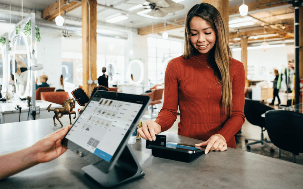 Woman swiping a credit card at a store. Blake Wisz/Unsplash