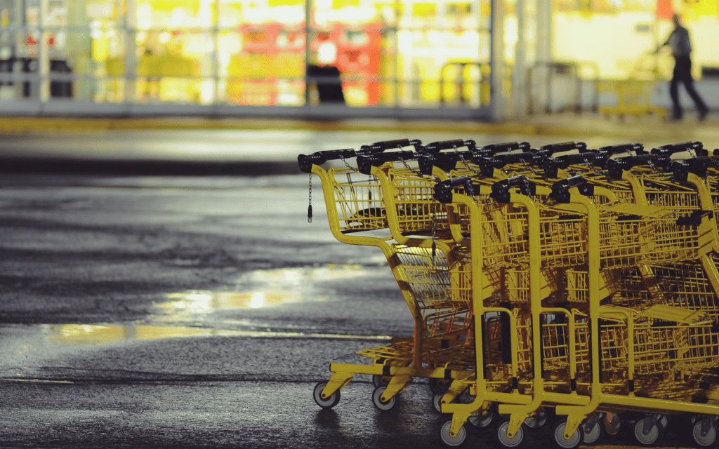 Yellow shopping carts stacked on a parking lot. Clark Young/Unsplash