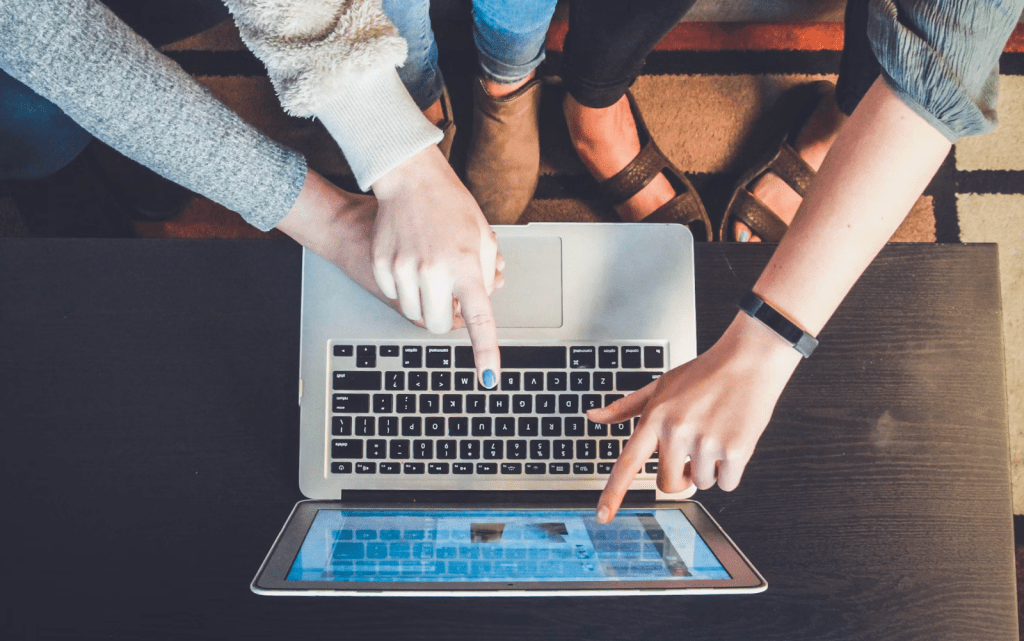 Women pointing at a laptop screen. John/Unsplash